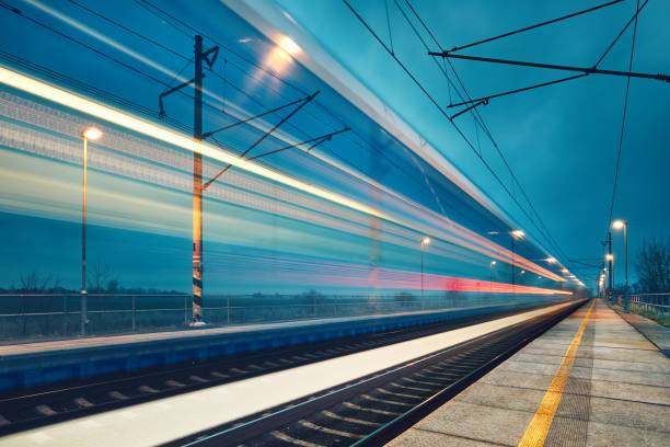 Light trail of the express train in the railway station at the night. Light trail of the express train in the railway station at the night.