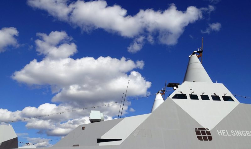 Stockholm, Sweden, June 4, 2022: a glimpse of a battleship docked at the pier. Stockholm, Sweden, June 4, 2022: a glimpse of a battleship docked at the city pier.